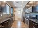 Sleek kitchen boasts dark cabinets, stainless steel appliances, and modern fixtures at 504 N Ranger Trl, Gilbert, AZ 85234