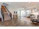 Bright living room features wood floors, ceiling fan, and a staircase to the upper level at 504 N Ranger Trl, Gilbert, AZ 85234