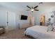 Bright main bedroom with light walls, ceiling fan, and neutral toned furniture at 504 N Ranger Trl, Gilbert, AZ 85234