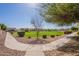 Scenic view of a well-maintained neighborhood park with lush greenery, sidewalks, and surrounding homes at 504 N Ranger Trl, Gilbert, AZ 85234