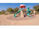 This vibrant community playground includes a colorful climbing structure and slides on a sand base at 504 N Ranger Trl, Gilbert, AZ 85234