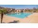 Community swimming pool features a large pool deck, and palm trees at 504 N Ranger Trl, Gilbert, AZ 85234