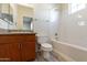 Bright bathroom featuring a tub-shower combo, wood vanity, and granite countertop at 5302 E Van Buren St # 2060, Phoenix, AZ 85008