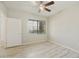 Bright bedroom with wood-look floors, ceiling fan, window, and neutral walls for a serene atmosphere at 5302 E Van Buren St # 2060, Phoenix, AZ 85008