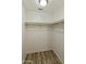 Walk-in closet with wood-style floor and white walls and shelving at 5302 E Van Buren St # 2060, Phoenix, AZ 85008