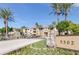 Apartment community entrance with lush landscaping and palm trees at 5302 E Van Buren St # 2060, Phoenix, AZ 85008