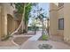 Beautiful courtyard with lush landscaping, a walkway, and water feature create a serene outdoor setting at 5302 E Van Buren St # 2060, Phoenix, AZ 85008