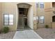 Tan apartment building with stairs leading to the second-floor entrance at 5302 E Van Buren St # 2060, Phoenix, AZ 85008