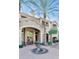 Inviting building exterior with a charming fountain and lush landscaping, enhancing the property's curb appeal at 5302 E Van Buren St # 2060, Phoenix, AZ 85008