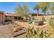 Serene backyard featuring desert landscaping, a cozy seating area, and mature trees for shade at 5507 N Calle Del Santo --, Phoenix, AZ 85018