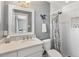 Stylish bathroom features a modern vanity, framed mirror, and a shower with decorative curtain at 5507 N Calle Del Santo --, Phoenix, AZ 85018