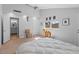 Bright main bedroom featuring neutral carpeting, updated ceiling fan, and a doorway to the en suite bathroom at 5507 N Calle Del Santo --, Phoenix, AZ 85018