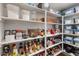 Organized pantry with white shelves stocked with food items and storage containers at 5507 N Calle Del Santo --, Phoenix, AZ 85018