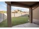 Covered patio overlooks a well-manicured backyard with block wall fence at 559 E Rainbow Dr, Chandler, AZ 85249