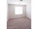 This bedroom features neutral carpeting and a sunlit window at 559 E Rainbow Dr, Chandler, AZ 85249