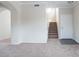 A well-lit staircase in an open-concept space, featuring carpeted stairs and tile flooring at 559 E Rainbow Dr, Chandler, AZ 85249