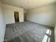 Spacious bedroom with plush carpet and abundant natural light at 5722 E Orion Rd, Florence, AZ 85132