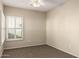 Cozy bedroom featuring neutral tones, carpeted flooring and shuttered window at 5826 E Nathan St, Mesa, AZ 85215