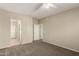 Spacious bedroom with neutral carpet and walls, featuring a ceiling fan and closet at 5826 E Nathan St, Mesa, AZ 85215