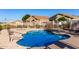 Community pool surrounded by decorative fencing with lounge chairs and nearby homes at 5826 E Nathan St, Mesa, AZ 85215