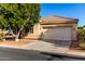 Charming single-story home featuring a well-maintained front yard with mature tree and a two-car garage at 5826 E Nathan St, Mesa, AZ 85215