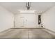 Spacious garage with concrete floors and a white door at 5826 E Nathan St, Mesa, AZ 85215