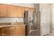 Close-up shot of a stainless steel refrigerator with granite counters and wood cabinetry at 5826 E Nathan St, Mesa, AZ 85215