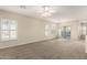 Expansive living room featuring neutral decor, carpeted floors, and large windows for natural light at 5826 E Nathan St, Mesa, AZ 85215