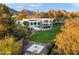 Expansive aerial view of a modern home featuring a pool, cabana, manicured lawn, and mountain backdrop at 6216 N 38Th Pl, Paradise Valley, AZ 85253