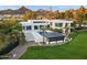 Beautiful modern home showcasing an outdoor living space with a pool, cabana, and lush green lawn at 6216 N 38Th Pl, Paradise Valley, AZ 85253