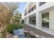 Modern home featuring a pond, lush landscaping, and a sleek exterior design at 6216 N 38Th Pl, Paradise Valley, AZ 85253