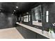 Elegant bathroom with a long black vanity, dual sinks, and modern sconces at 6216 N 38Th Pl, Paradise Valley, AZ 85253