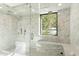 Stunning marble shower with glass enclosure, rainfall showerhead, and a built-in bench at 6216 N 38Th Pl, Paradise Valley, AZ 85253