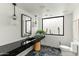 Modern bathroom featuring a black marble countertop, a unique mirror, and stylish lighting at 6216 N 38Th Pl, Paradise Valley, AZ 85253