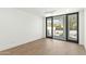 Minimalist bedroom featuring hardwood floors and sliding doors to a balcony with mountain views at 6216 N 38Th Pl, Paradise Valley, AZ 85253