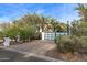 Daytime view of the driveway with pavers, palm trees, and greenery surrounding a modern home at 6216 N 38Th Pl, Paradise Valley, AZ 85253