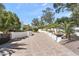 Beautiful winding driveway with patterned brick, desert landscaping, and a white privacy wall at 6216 N 38Th Pl, Paradise Valley, AZ 85253