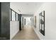 Hallway with modern art, wainscoting and herringbone wood floors leading to various areas of the home at 6216 N 38Th Pl, Paradise Valley, AZ 85253