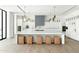 Modern, all-white kitchen with large island, seating, and unique pendant lighting at 6216 N 38Th Pl, Paradise Valley, AZ 85253