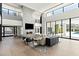 Bright living room with a soaring fireplace, large windows, and modern decor at 6216 N 38Th Pl, Paradise Valley, AZ 85253