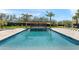 A pristine pool features an overhang for relaxing with a backyard view and multiple palm trees at 6216 N 38Th Pl, Paradise Valley, AZ 85253