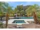 A tranquil backyard oasis with a pool, jacuzzi, and mature palm trees for added privacy and natural beauty at 6216 N 38Th Pl, Paradise Valley, AZ 85253