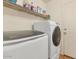 Functional laundry room featuring a modern washer and dryer set and storage shelving at 648 W Cobblestone Dr, Casa Grande, AZ 85122