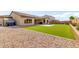 Exterior backyard view featuring artificial turf, desert landscaping and a storage shed at 7630 E Knoll St, Mesa, AZ 85207