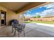 Covered patio overlooking an artificial lawn and beautiful landscaping at 7630 E Knoll St, Mesa, AZ 85207