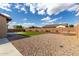 Desert landscaped backyard with artificial turf and a stone retaining wall at 7630 E Knoll St, Mesa, AZ 85207