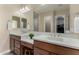 Bathroom featuring double sinks with quartz countertops and a well-lit mirror at 7630 E Knoll St, Mesa, AZ 85207