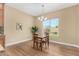 Cozy dining area with a window overlooking backyard and hardwood floors at 7630 E Knoll St, Mesa, AZ 85207