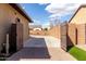 Gated, open driveway with an extended area for additional parking at 7630 E Knoll St, Mesa, AZ 85207