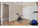 A home gym with exercise bike, yoga ball, and hardwood floors at 7630 E Knoll St, Mesa, AZ 85207